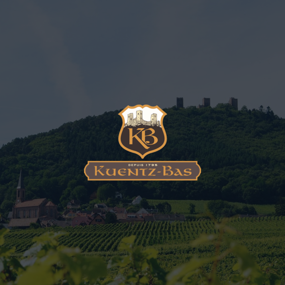 Kuentz-bas logo on a low opacity background of their wine fields